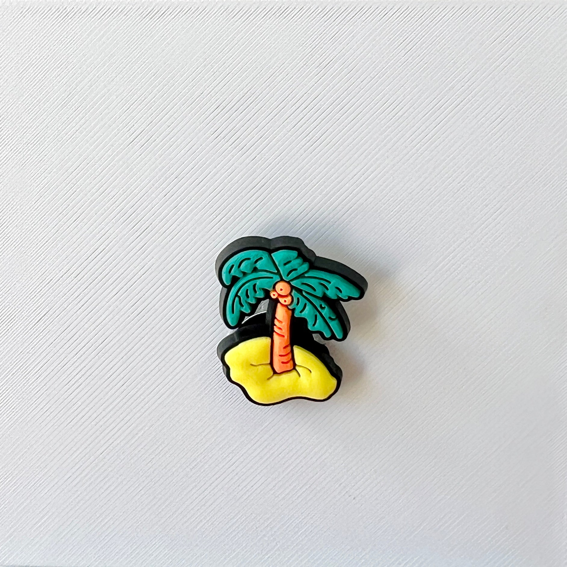 Colorful palm tree on a sandy base, set against a textured white background, evoking a tropical vibe.