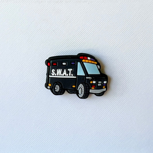 A black vehicle with "S.W.A.T." written on the side, featuring colorful lights and cartoonish design elements.