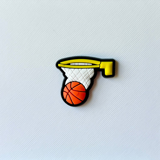 Colorful basketball hoop with a ball, set against a textured white background, showcasing vibrant details and playful design.