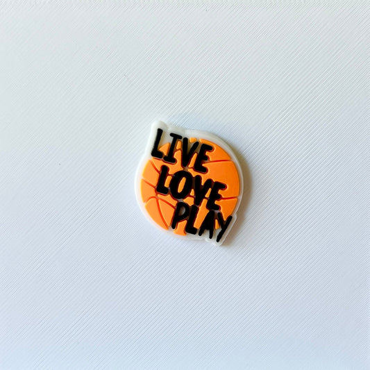 A round, orange piece featuring the phrase "LIVE LOVE PLAY" in bold black letters against a textured white background.