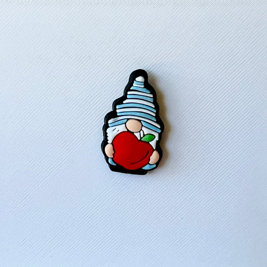 A whimsical character with a blue striped hat holds a bright red apple against a textured white background.