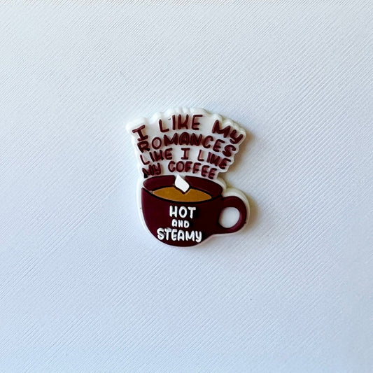 A whimsical coffee cup with the phrase "I like my romances like I like my coffee: hot and steamy" in playful typography.
