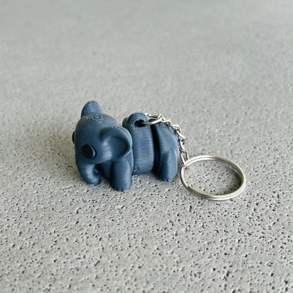 Charming dark grey elephant keychain with a playful design, perfect for keeping keys organized and adding a fun touch.