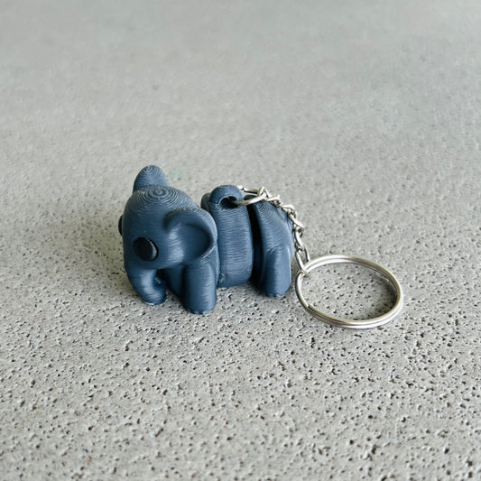 Charming dark grey elephant keychain with a playful design, perfect for keeping keys organized and adding a fun touch.