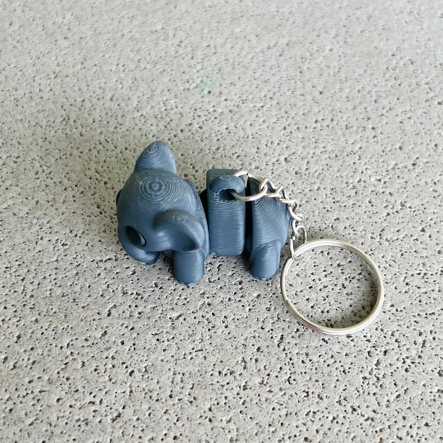 Dark grey elephant keychain with playful details, perfect for organizing keys and adding a fun touch to your accessories.