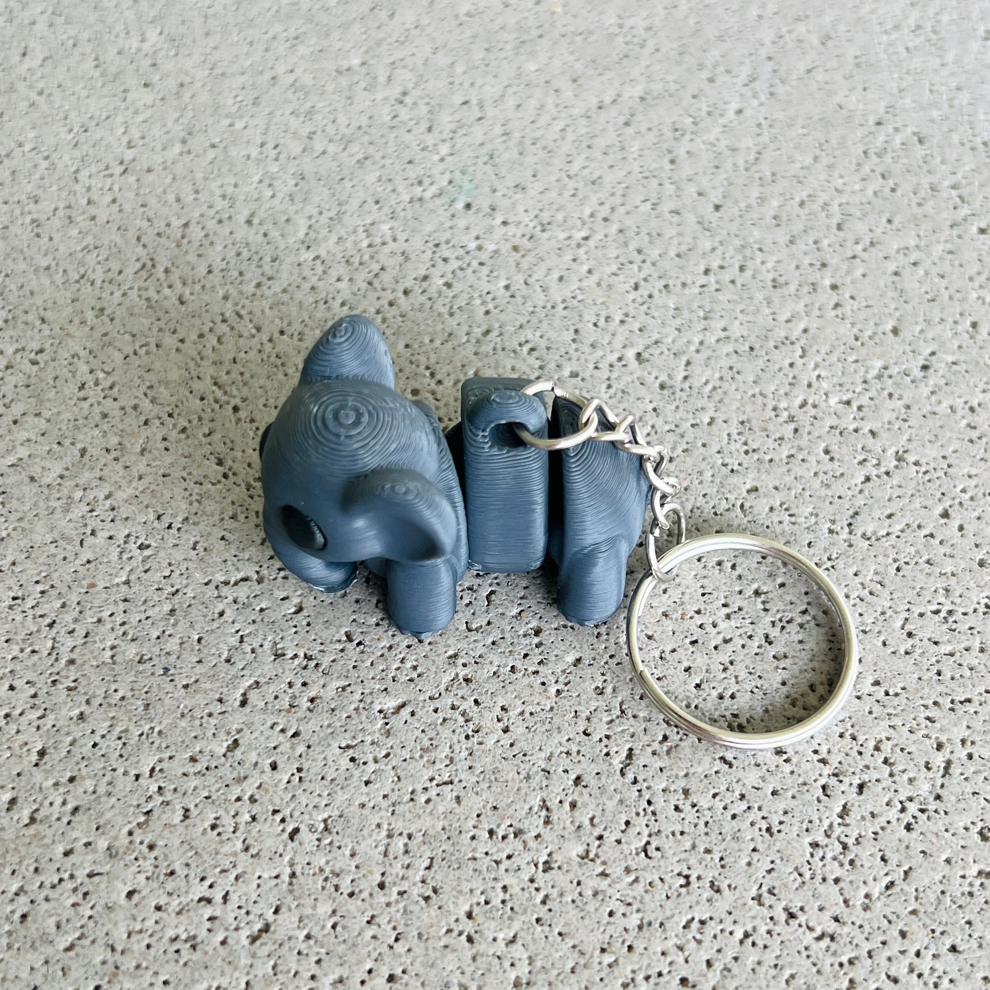 Dark grey elephant keychain with playful details, perfect for organizing keys and adding a fun touch to your accessories.
