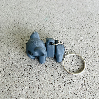 Dark grey elephant keychain with playful details, perfect for organizing keys and adding a fun touch to your accessories.