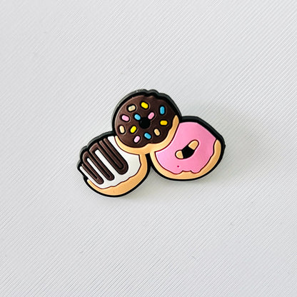 Adorable shoe charm featuring three colorful mini donuts with sprinkles and icing, perfect for personalized footwear.