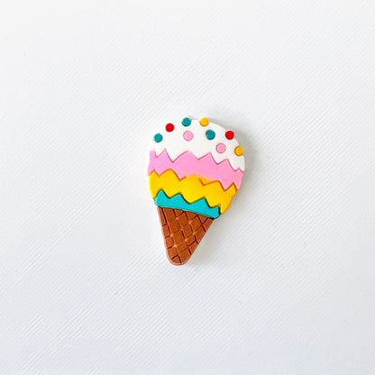 Colorful ice cream cone charm with blue, yellow, pink, and white scoops topped with sprinkles, perfect for fun footwear!