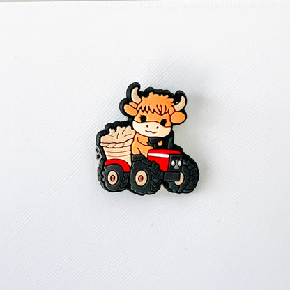 Adorable Highland cow driving a red tractor, perfect for adding farmyard charm to your footwear.