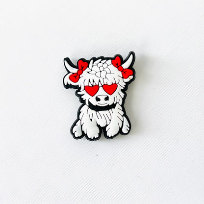 White Highland cow charm with red heart eyes and bows, adding a playful touch to shoes for animal lovers and romantics.