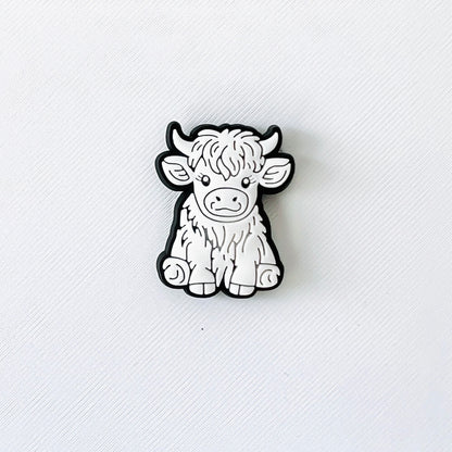 Adorable white Highland cow charm with long hair, perfect for adding flair to your shoes and delighting animal lovers.