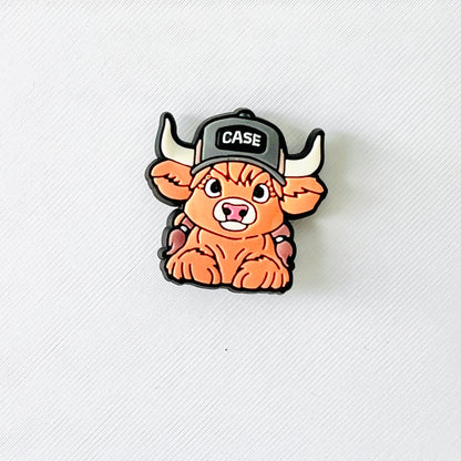 A cute Highland cow with a cap, perfect for adding playful charm to your shoes. Great for animal lovers!