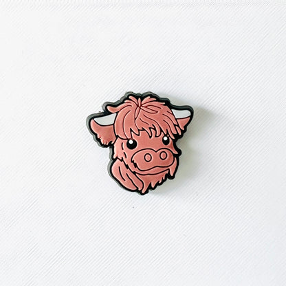 Adorable brown Highland cow face charm with fluffy fur and sweet expression, perfect for personalizing shoes.