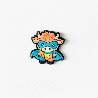 Fluffy Highland cow in a blue superhero cape and mask, complete with a star, perfect for quirky shoe flair.