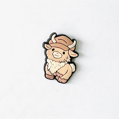 Fluffy Highland cow with a cap, perfect for adding a fun touch to your shoes and great for cow lovers.