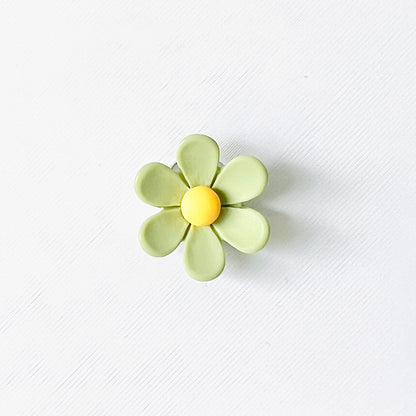 Cheerful green flower charm with yellow center, perfect for adding a nature-inspired touch to your footwear.
