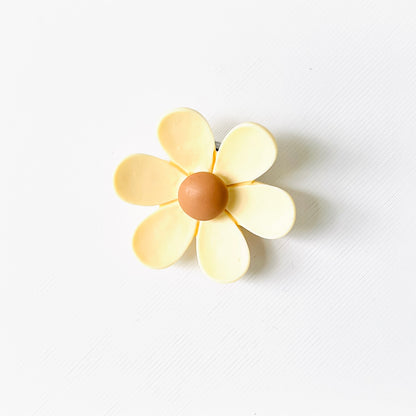 Cream flower charm with soft petals and a rich brown center, perfect for adding a floral touch to footwear.