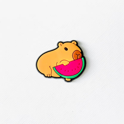 Adorable capybara holding a bright pink watermelon slice, perfect for adding charm to your summer footwear.