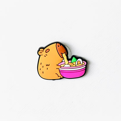 Adorable capybara enjoying a warm bowl of ramen, featuring vibrant colors and playful details. Perfect for shoe accessories!
