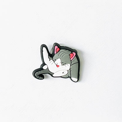 Adorable grey and white cat charm in a relaxed pose, perfect for adding feline flair to your footwear.