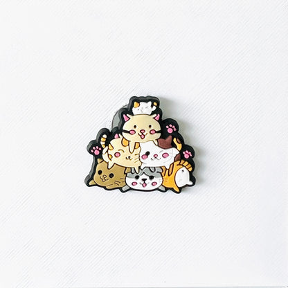 Cute stacked cats in playful colors, balancing on top of each other, perfect for adding charm to your shoes.