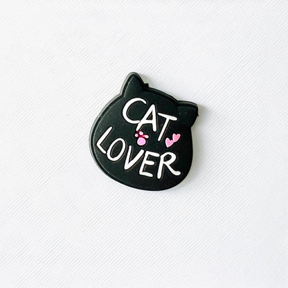 Black cat face charm with "Cat Lover" text, featuring pink paw prints and hearts, perfect for shoe personalization.