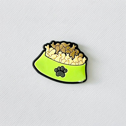 Charming green bowl filled with fish-shaped biscuits, featuring a cute paw print, perfect for adding flair to shoes.