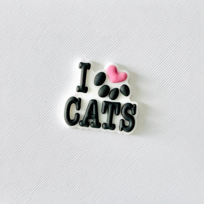 Charming "I ❤️ Cats" shoe accessory with a paw print, perfect for cat lovers and easy to attach to shoes.