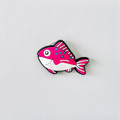 Colorful pink and white fish charm with playful details, perfect for adding flair to footwear for ocean lovers.