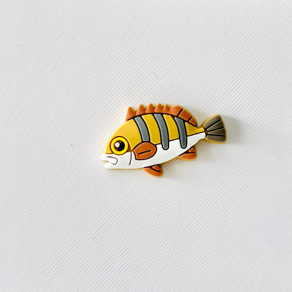 Colorful fish charm featuring yellow and orange stripes, perfect for adding fun to footwear for sea life lovers.