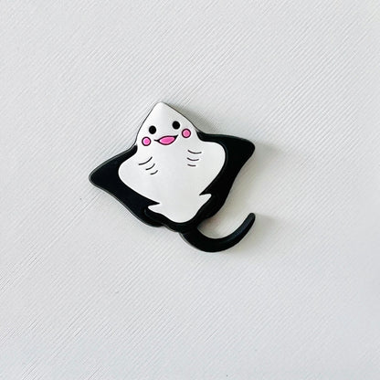 Adorable smiling stingray charm in black and white, perfect for adding a fun ocean touch to your shoes.
