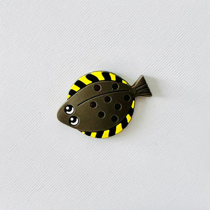 Cute flounder fish charm with a flat body and playful yellow stripes, perfect for adding ocean flair to your shoes.