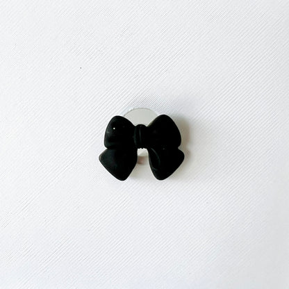 Elegant black bow charm on a white background, perfect for adding chic style to shoes. Easy to attach and remove.