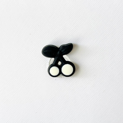 Black and white cherries charm with a sleek design, perfect for adding flair to shoes. Ideal for retro and fruit lovers.