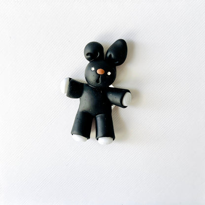 Adorable black bunny charm with white paws and nose, perfect for adding whimsy to shoes for animal lovers.