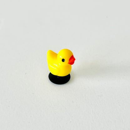 Bright yellow duck charm with a cheerful expression, featuring black base and glossy finish, perfect for footwear decoration.