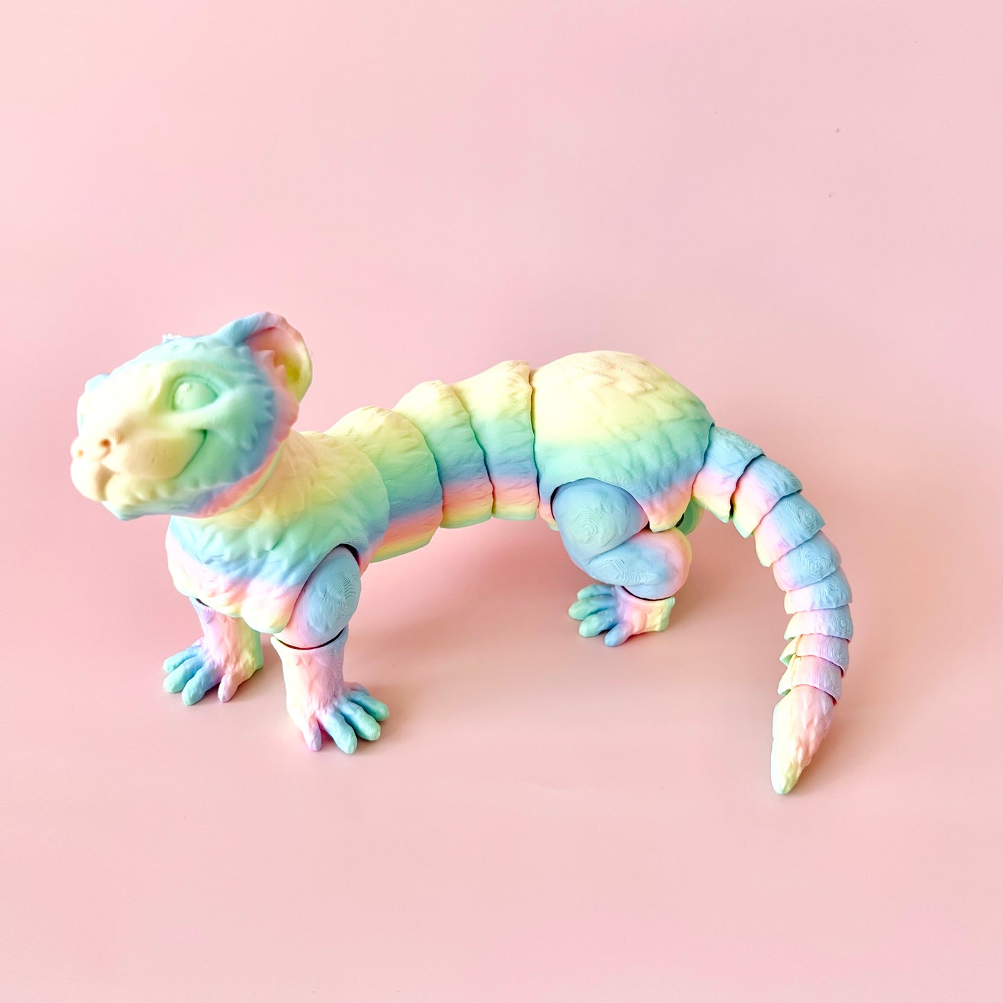 A colorful, articulated ferret figurine with intricate details, perfect for collectors and animal lovers.