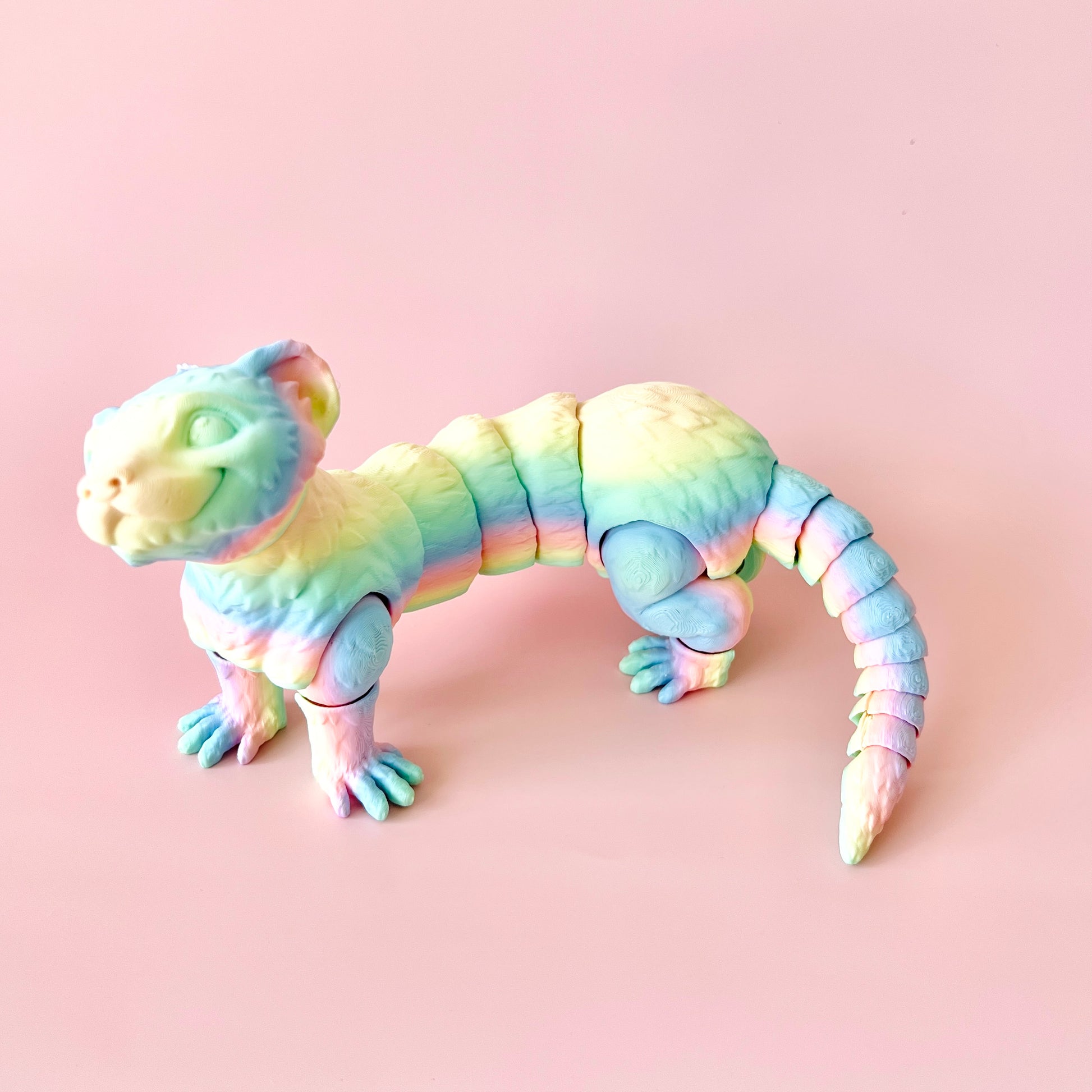 A colorful, articulated ferret figurine with intricate details, perfect for collectors and animal lovers.