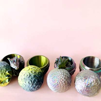 Colorful, custom 3D-printed eggs with intricate textures and a hidden dragon companion peeking out from one.