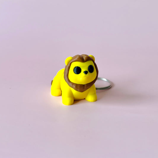 A cheerful yellow figure with a brown mane, resembling a playful lion, set against a soft pink background.