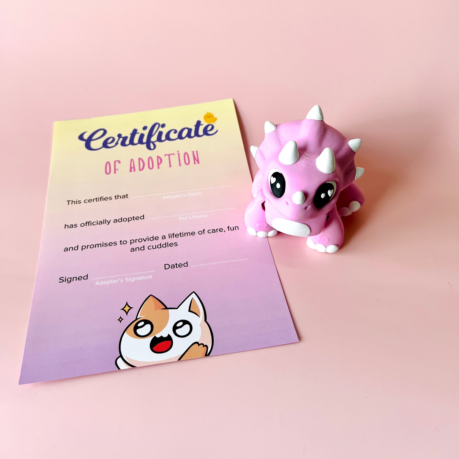 A playful pink creature beside a colorful adoption certificate on a soft pastel background.