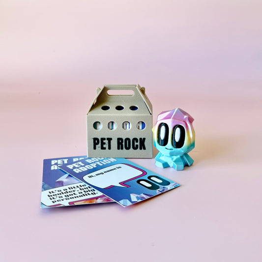 A colorful, whimsical figure with large eyes beside a small carrier and adoption cards on a pink background.