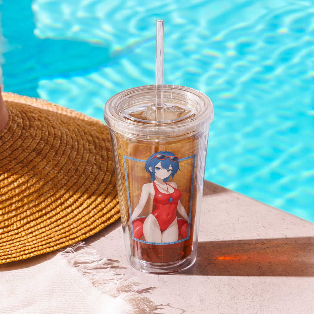 Clear tumbler featuring a character in a red swimsuit, set beside a sunhat and sparkling blue water.