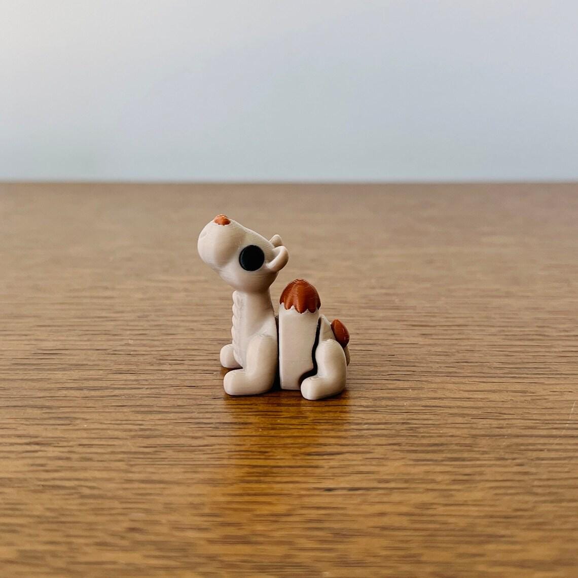 A cute, articulated mini camel with brown accents, perfect for sensory play or as a charming collectible.