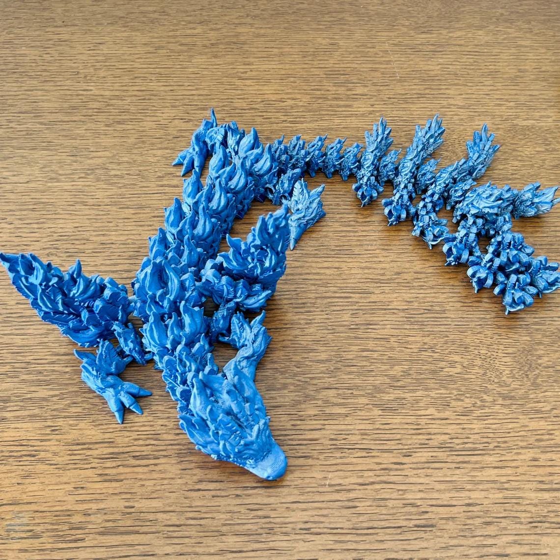 Majestic blue Phoenix Dragon with intricate detailing, powerful wings, and impressive length, perfect for fantasy collectors.