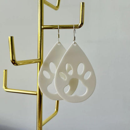 White paw print dangle earrings with sterling silver hooks, showcasing a playful yet elegant design, perfect for everyday wea