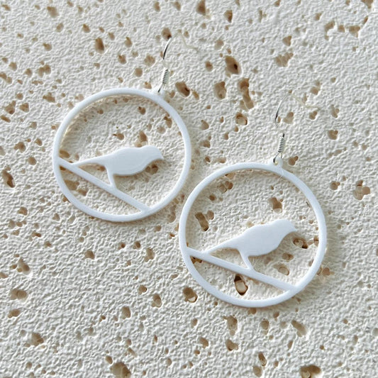 Elegant white bird dangle earrings made with lightweight plastic and sterling silver hooks, perfect for any occasion.