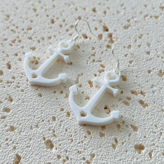 White anchor dangle earrings with sterling silver hooks, perfect for a nautical style, adding elegance and movement.