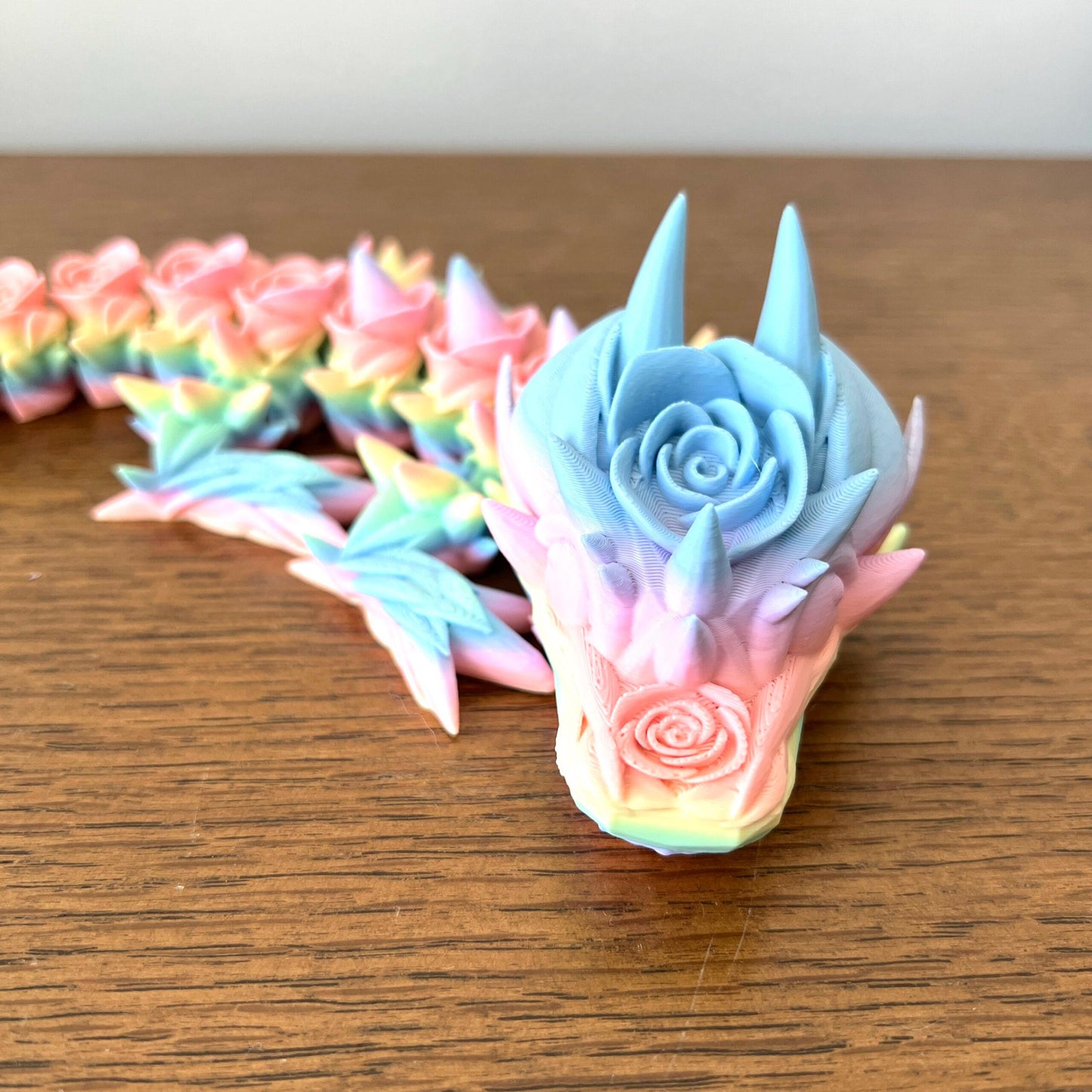 Enchanting pastel-hued Baby Rose Dragon with intricate floral details, perfect for collectors and fantasy lovers.